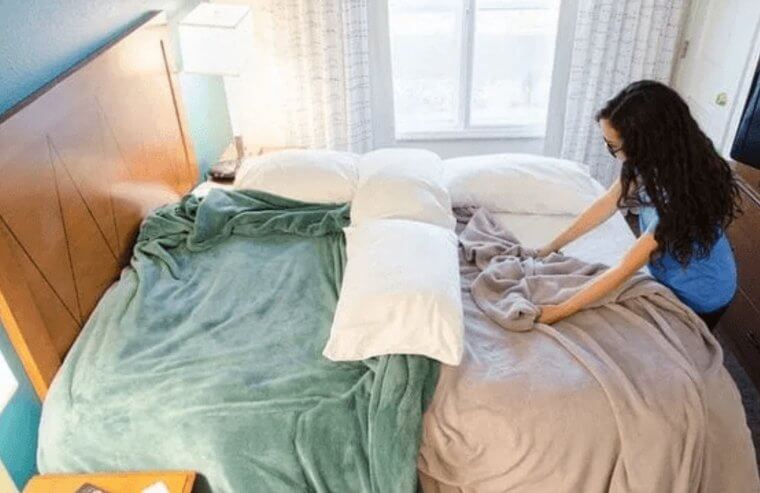 Use Pillows and Extra Sheets as Bed Dividers